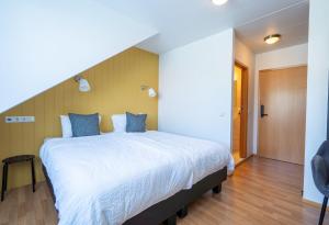 Postel nebo postele na pokoji v ubytování Hotel Breiddalsvik