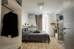 a small bedroom with a bed and a glass door at Casa l'Orologio in Barletta
