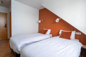 Postel nebo postele na pokoji v ubytování Hotel Breiddalsvik