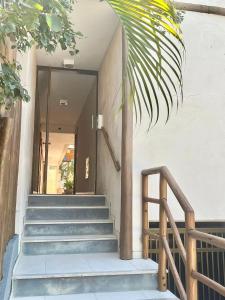 a set of stairs leading up to a building at Moderno 1 Quarto Dentro da Vila in Praia do Forte