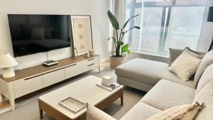 a living room with a large flat screen tv at Piso Porta do Sol in Ribeira