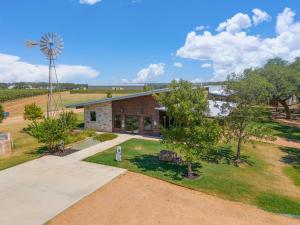 an aerial view of a farm house with a windmill at Ab Astris - Starry Night Cottage 1 in Stonewall