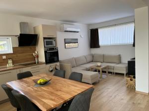 a kitchen and living room with a table and a couch at Trinity House in Obrochishte