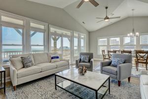 a living room with a couch and chairs and a table at Beachfront Memories by Sea Scape Properties in North Topsail Beach