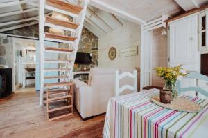 a room with a table and chairs and a ladder at El Pino Centenario 4B in La Perdoma