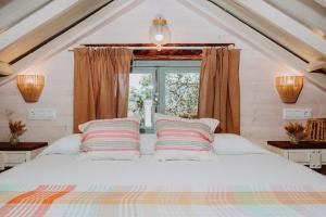 a bedroom with a bed with two pillows and a window at El Pino Centenario 4B in La Perdoma