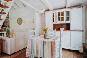 a kitchen with a table with a striped table cloth at El Pino Centenario 4B in La Perdoma +20 photos