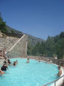 a group of people in a large swimming pool at Belle maison Catalan, rénovée entièrement 2023 in Eus