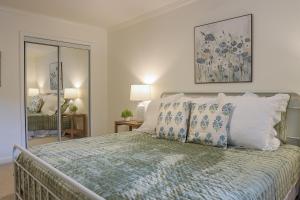a bedroom with a bed with blue and white pillows at Oxford Condo in Oxford
