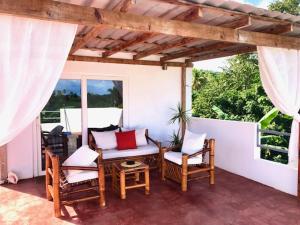 a patio with chairs and a table and a table and chairs at Villa KAMBUSA in Las Galeras