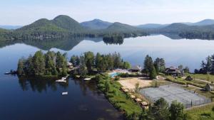 an aerial view of a house on a lake at Lakefront Mountain View - Resort Studio in Lac-Superieur