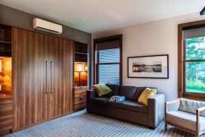 a living room with a couch and a chair at Lakefront Mountain View - Resort Studio in Lac-Superieur +31 photos