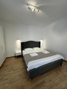 a bedroom with a large bed in a white room at Nord 22 in Constanţa