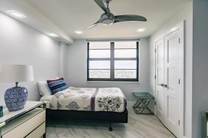 een slaapkamer met een bed en een plafondventilator bij 2 BR Condo by the Beach - Splendid Ocean View in Marco Island +25 foto's