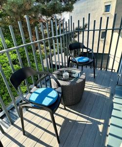 two chairs and a table on a deck at Hotel National in Zagreb