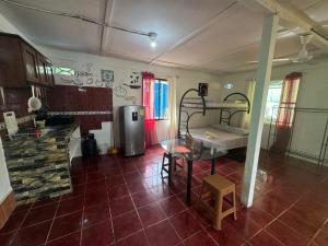 a kitchen with a room with a table and a room with a kitchen at Shalon Apartments 4 personas in Cahuita