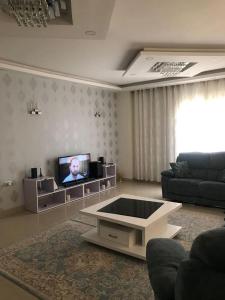 a living room with a couch and a tv at شقة مفروشة Furnished apartment in 6th Of October
