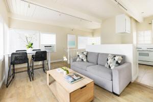 a living room with a couch and a table at Pacific Edge Hotel in Laguna Beach