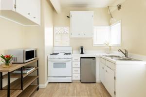 a white kitchen with a sink and a stove at Pacific Edge Hotel in Laguna Beach +113 photos