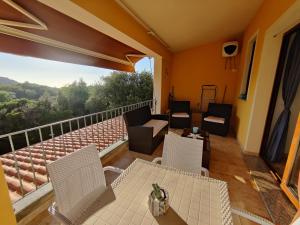 a balcony with chairs and a table and a view at Tana della Volpe in Arbus