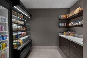 a kitchen with a refrigerator and shelves of food at Hotel 43 Boise in Boise