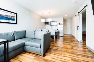 a living room with a couch and a kitchen at The Windstar Hotel - Carolina Beach in Carolina Beach