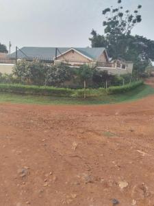 a house with a dirt road in front of a house at Tranquil Tororo Retreat in Tororo