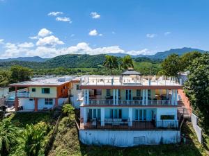 an aerial view of a house with mountains in the background at 3 Villas with Stunning Views & 2 Private Pools in Luquillo