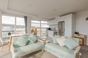 a living room with a couch and a table at Harbor View Two Bedroom Apartment At Pinnacle in Wellington +10 photos