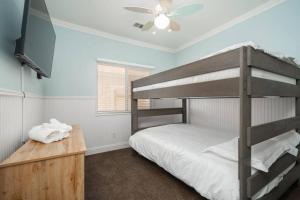 a bedroom with a bunk bed and a flat screen tv at Central Bliss near parks & shops in Bakersfield