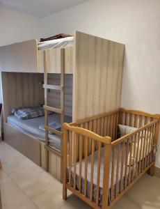 a bunk bed with a crib in a room at Dule Lux in Jagodina