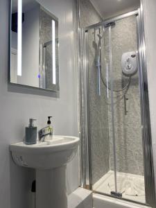 a white bathroom with a sink and a shower at The Lowther Hotel in York