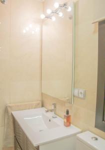 a bathroom with a sink and a mirror at Apartamento Boutique TOKIO in Garrucha