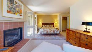 a bedroom with a bed and a fireplace at Cottonwood Condo 1413 in Sun Valley +26 photos