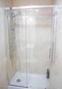 a shower with a glass door in a bathroom at Apartamento Boutique TOKIO in Garrucha