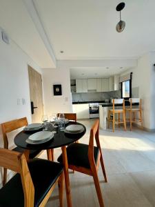 a dining room and kitchen with a table and chairs at Augusto Apart 4 in Salta