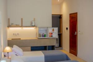 a hotel room with a bed and a kitchen at Hotel Cerros del Norte in Tilcara