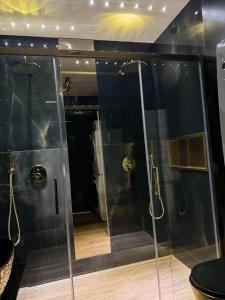 a bathroom with a walk in shower and a glass shower stall at Apartament z jacuzzi, Wiślane Tarasy in Krakow +11 photos