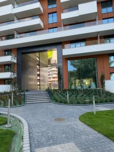 a building with a walkway in front of it at Apartament z jacuzzi, Wiślane Tarasy in Krakow