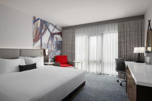 a hotel room with a bed and a red chair at Hotel 43 Boise in Boise +43 photos