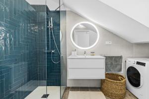 a bathroom with a sink and a washing machine at Casa Conchi Puerto del Carmen in Puerto del Carmen +22 photos