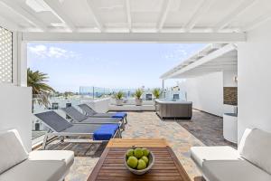 a living room with couches and a table at Casa Conchi Puerto del Carmen in Puerto del Carmen