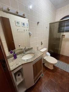 a bathroom with a sink and a toilet at Caribean Praia das Toninhas - A 100 metros da areia 21A in Ubatuba +47 photos