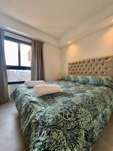a bedroom with a large bed with two pillows on it at Augusto Apart 4 in Salta +67 photos