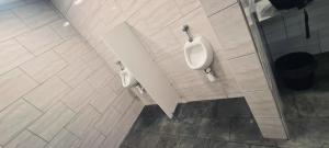 a bathroom with two urinals on the wall at COSY BOAT FLAT at BARCELONA BEACH in Barcelona