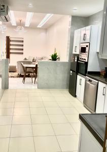 a kitchen with white appliances and a dining room at شقه مفروشه مميزه 3 in Obhor