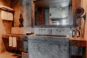 a bathroom with a large sink and a mirror at Nomade Tulum in Tulum