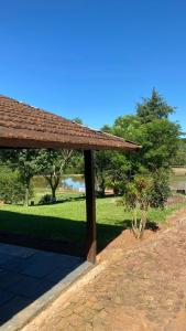 a pavilion in a park with trees and grass at Casa de Campo Rancho Bodaneze in Abelardo Luz