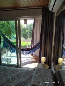 a bedroom with a hammock and a view of a porch at Flat 207 Villa Hípica - Gravatá in Gravatá +50 photos