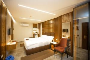 a hotel room with a bed and a chair at New Comfort Inn Giza in Cairo